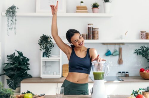 Frau bereitet einen Smoothie mit veganem Protein Pulver zu als Symbol für Plant Protein Lifestyle und moderne High Protein Frühstückstrends.